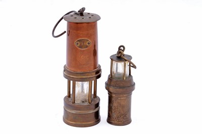 Lot 245 - Four figural studies of miners; and a selection of miniature or presentation miner’s lamps