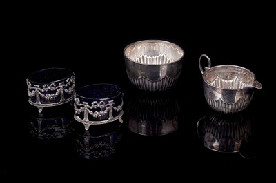 Lot 165 - A late Victorian silver cream jug and sugar bowl; and a pair of Edwardian silver salts