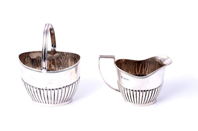 Lot 178 - A 1920s silver cream jug and sugar basket