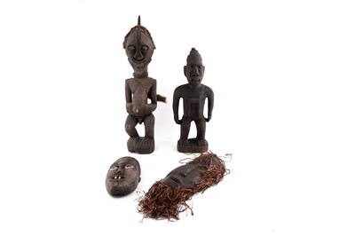 Lot 217 - Two African style carved hardwood figures and two masks