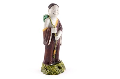 Lot 312 - A Chinese porcelain figure of Liu Haichan