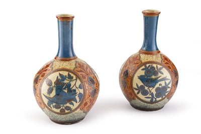 Lot 392 - A pair of C. H. Brannam slipware bottle vases