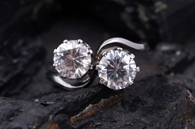 Lot 60 - A modern two-stone cubic zirconia ring